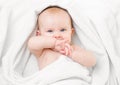 Cute baby lying on white towel and sucking own Royalty Free Stock Photo
