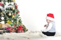 Cute baby one year boy playing with Christmas tree decoration Royalty Free Stock Photo