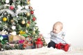 Cute baby one year boy playing with Christmas tree decoration Royalty Free Stock Photo