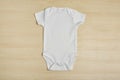 Cute baby onesie on wooden background Royalty Free Stock Photo