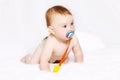 Cute baby with pacifier on the bed Royalty Free Stock Photo