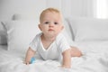 Cute baby with pacifier lying on bed Royalty Free Stock Photo