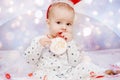 Cute baby in pajamas and deer horns on christmas background Royalty Free Stock Photo