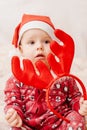 Cute baby in pajamas and santa claus hat on christmas background Royalty Free Stock Photo