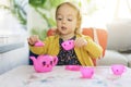 Cute baby play with pink tea cup at home Royalty Free Stock Photo