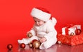 Cute baby playing with christmas presents and decorations Royalty Free Stock Photo