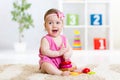Cute baby playing with colorful toy pyramid