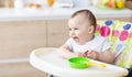 Cute baby playing with toy pan and kitchen spatula Royalty Free Stock Photo