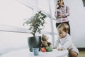 Cute Baby Playing while Young Mother Telephones Royalty Free Stock Photo