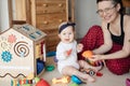 Cute baby plays with mom and rejoices. Family portrait Mom and Baby.