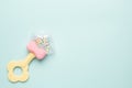 Cute baby rattle with teether on light blue background with copyspace Royalty Free Stock Photo