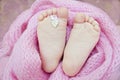 Cute baby`s feet covered in the pink wrap Royalty Free Stock Photo