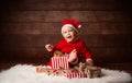 Cute Baby Santa Claus Happy Smiling sitting with Christmas Presents Royalty Free Stock Photo