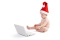 Cute baby Santa isolation on white background. Little boy in a Santa hat in studio, with a white laptop. Santa boy Royalty Free Stock Photo