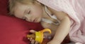 Cute baby sleeping on the bed at home. Little girl sleeping in morning light