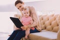 Cute baby smiling while a babysitter showing her lovely pictures Royalty Free Stock Photo