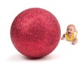 Cute Baby smiling at a Huge Christmas Ornament on white