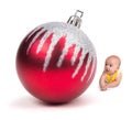 Cute Baby smiling at a Huge Christmas Ornament on white