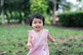 Cute baby smiling and running at the park