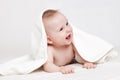 Cute baby smiling under white blanket