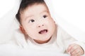 Cute baby smiling under a white blanket or towel Royalty Free Stock Photo