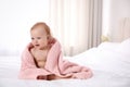 Cute little baby with soft pink towel on bed after bath. Space for text Royalty Free Stock Photo