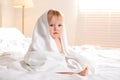 Cute little baby with soft towel on bed after bath Royalty Free Stock Photo