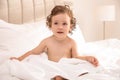 Cute little baby with soft towel on bed after bath Royalty Free Stock Photo