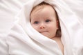 Cute little baby with soft towel lying on bed after bath, closeup Royalty Free Stock Photo