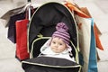 Cute Baby In Stroller Hung With Shopping Bags