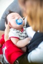 Cute baby is sucking pacifier and sleeping on a soft white carpet. Lovely baby lie down on a soft white carpet. image for backgrou Royalty Free Stock Photo