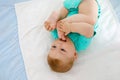 Cute baby taking feet in mouth. Adorable little baby girl sucking foot. Royalty Free Stock Photo