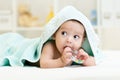 Cute baby with teether under towel indoor Royalty Free Stock Photo