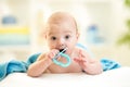 Cute baby with teether under towel indoor Royalty Free Stock Photo