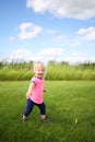 Cute Baby Toddler Girl Runing OUtside in the Grass on a Summer D Royalty Free Stock Photo