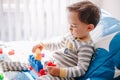 Cute baby toddler playing building with learning toy stacking blocks at home. Early age education. Kids hand brain and fine motor Royalty Free Stock Photo