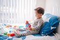 Cute baby toddler playing building with learning toy stacking blocks at home. Early age education. Kids hand brain and fine motor Royalty Free Stock Photo