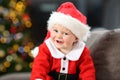 Cute baby wearing santa disguise looking at you