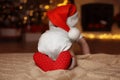 Cute little baby wearing Santa hat on blanket at home, back view. Christmas celebration Royalty Free Stock Photo