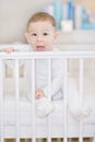 Cute baby in the white crib - portait of a lovely child