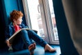 cute barefoot boy with book sitting