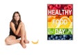 Cute barefoot girl in front of a photo with colorful fruits and vegetables