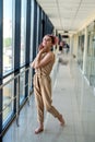 Cute barefoot woman standing inside building