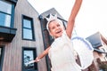 Cute beaming little girl feeling simply amazing while walking outside