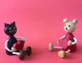 Cute bear and black cat carry heart wood toys Royalty Free Stock Photo