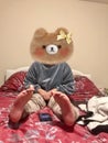 A cute bear girl sitting on bed Royalty Free Stock Photo