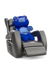 cute bear is relaxing on the recliner chair