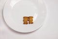 Cute bears cookies on the ceramic round plate on white background. View from above, flat lay