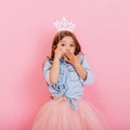 Cute beautiful carnival kid having fun  on pink background. Pretty little girl with long brunette hair, in tulle Royalty Free Stock Photo