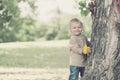 Cute beautiful child having fun in warm autumn day in park